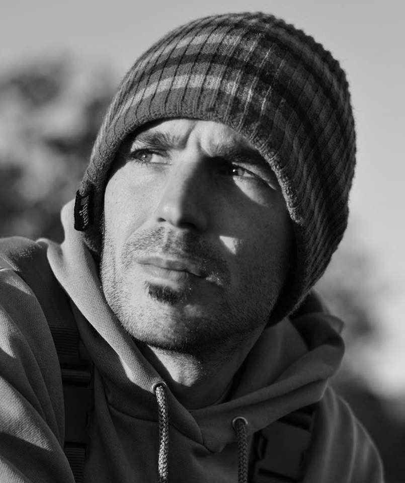 James Smith in a woolly hat, in black and white