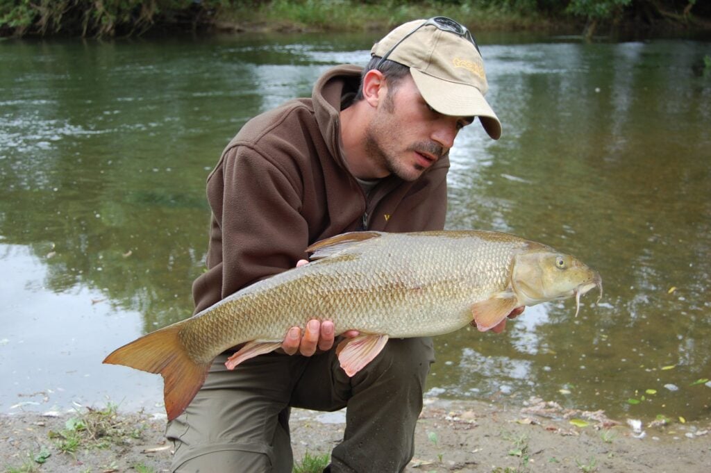 James with a barbel by the river